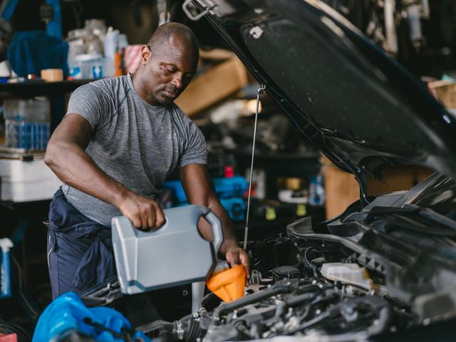 Engine oil being poured into the filler neck during a service